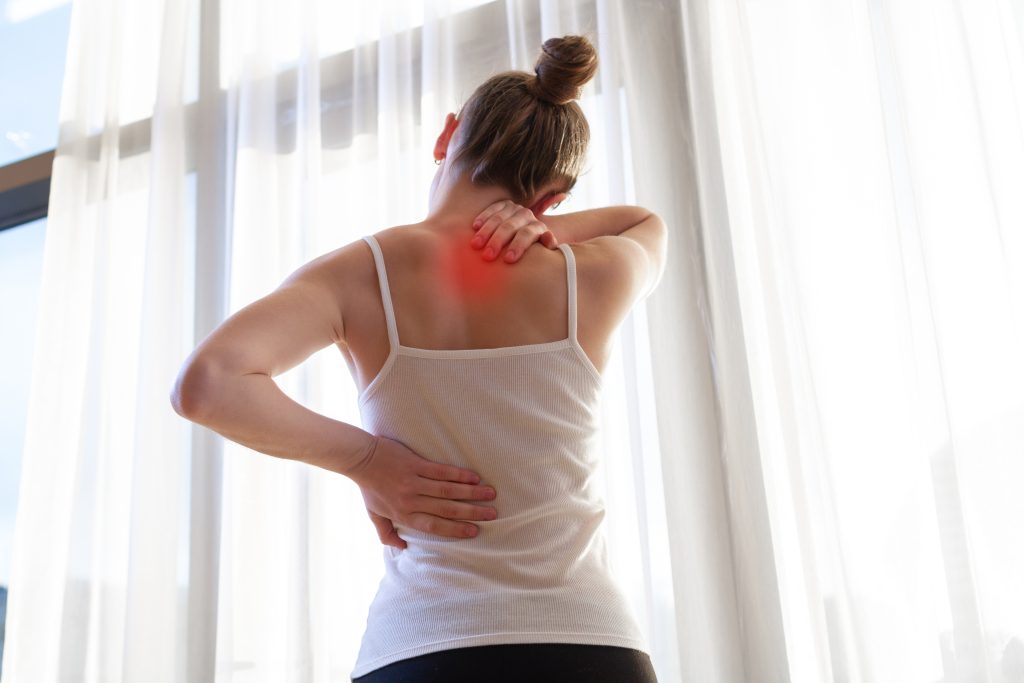 young woman suffering from neck pain backache stretching muscles home back neck pain woman scaled