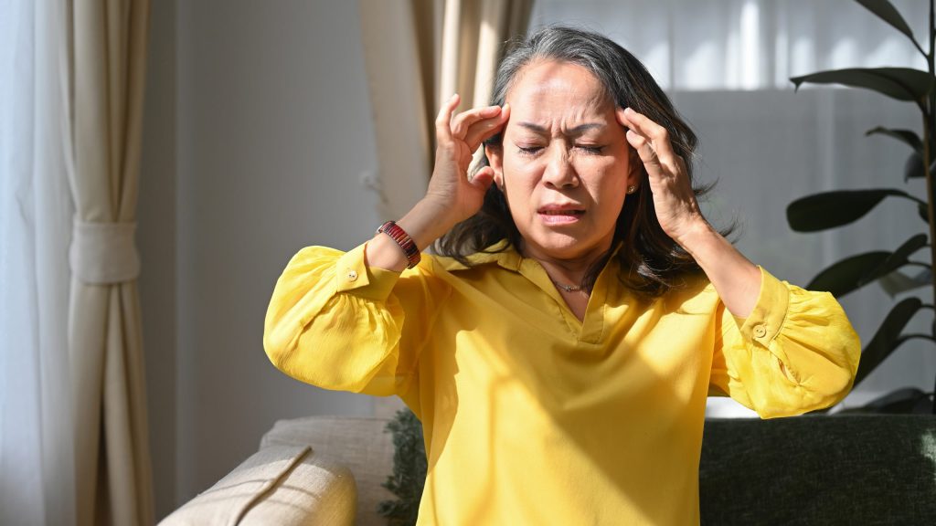 upset mature woman touching her head suffering from head ache migraine dizziness age medicine health care people concept scaled e1688245100943